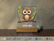 a glass block with a picture of an owl sitting on a branch