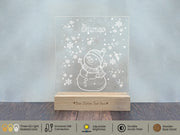 a glass block with a snowman on it