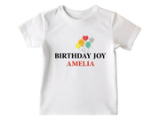 a white birthday shirt with balloons on it
