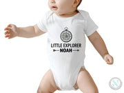 a baby wearing a bodysuit that says little explorer noah