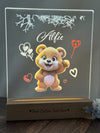 a clear acrylic with a picture of a teddy bear