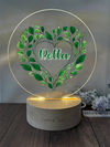 a personalized glass plaque with a heart and leaves