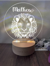 a light up lion head on a wooden base