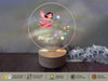 a glass ball with a picture of a fairy on it