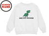 a white sweatshirt with a green dinosaur on it