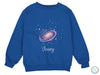 a blue sweatshirt with a picture of a saturn on it