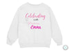 a white sweatshirt with the words celebrating with princess aurora on it