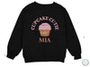 a black sweatshirt with a cupcake cutie on it