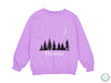 a purple sweatshirt with a forest scene on it