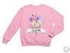 a pink sweatshirt with a bouquet of flowers on it