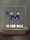 a glass block with the letter m is for max