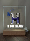 a glass block with the letter h is for harry